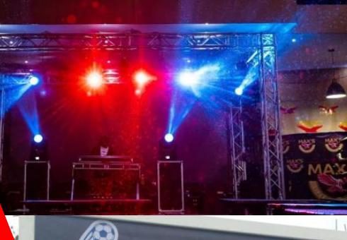 DJ booth under red and blue truss lighting