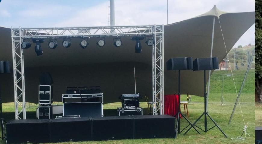 Outdoor marquee and stage rig set up on a field